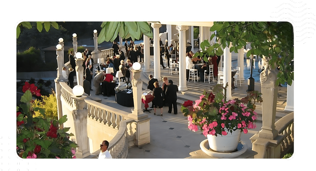 A group of people sitting around in front of some pillars.